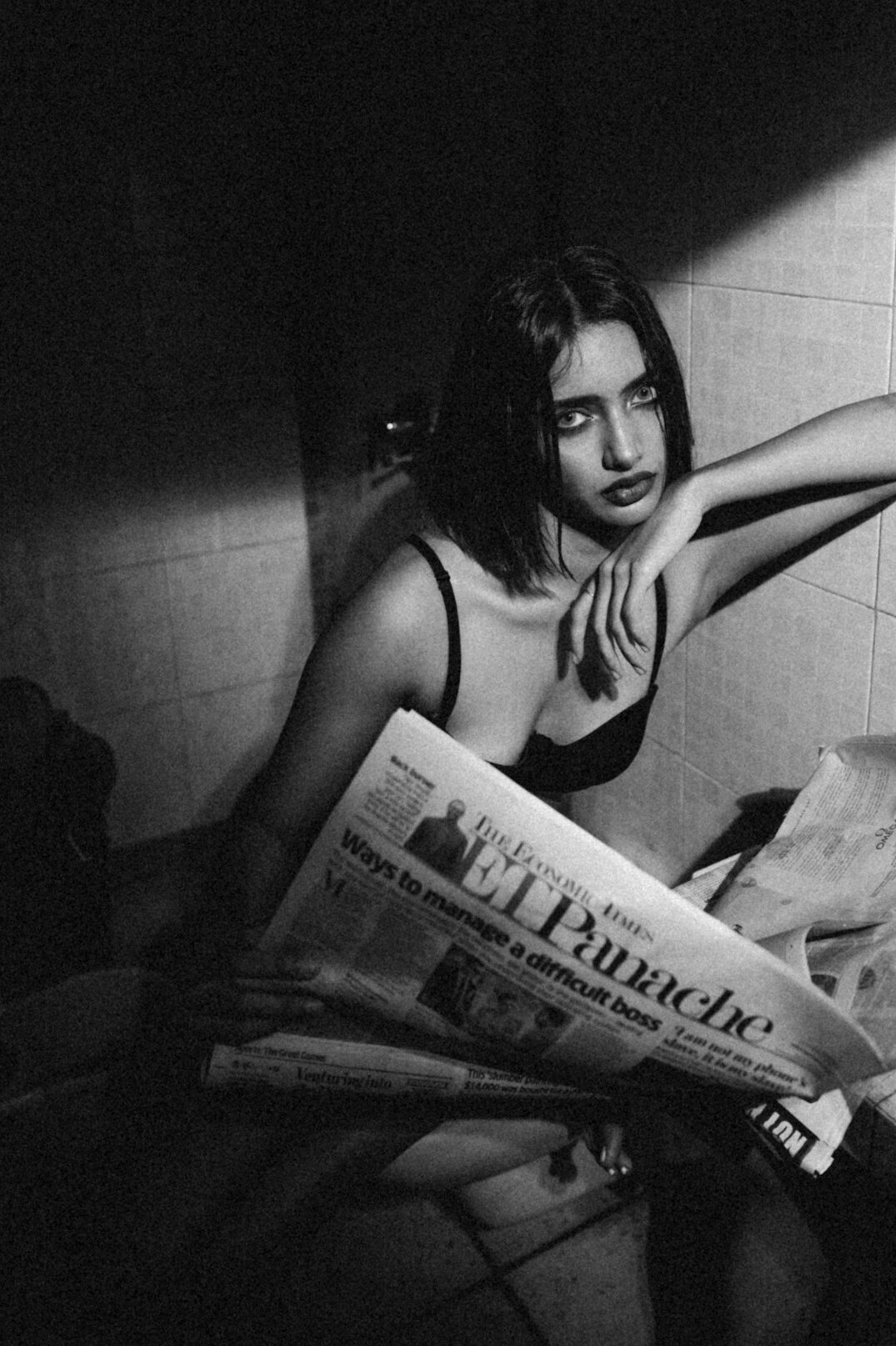 Person reading a newspaper at a desk